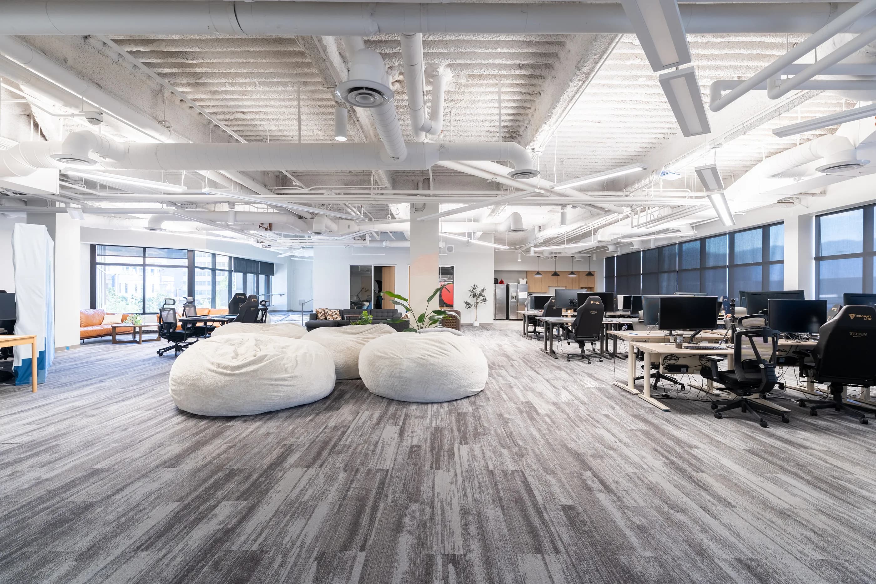 Wide view of the bright open lounge and furnished work area at The Space at 250